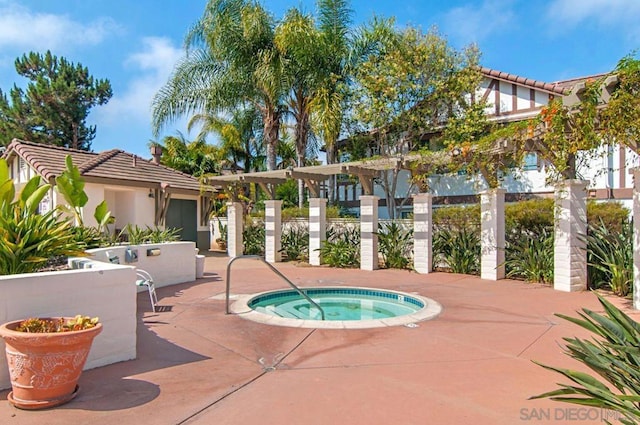 view of swimming pool with a patio area and a hot tub