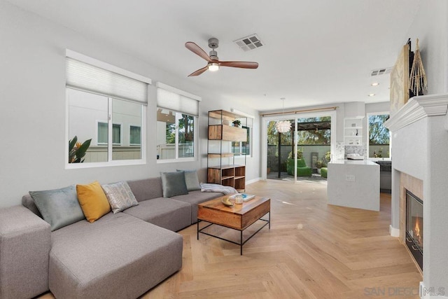 living room with ceiling fan and light parquet flooring