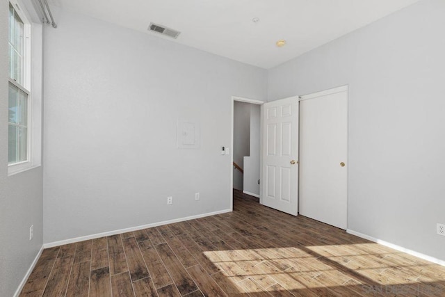 spare room featuring dark hardwood / wood-style floors