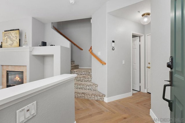 interior space featuring light parquet floors and a fireplace