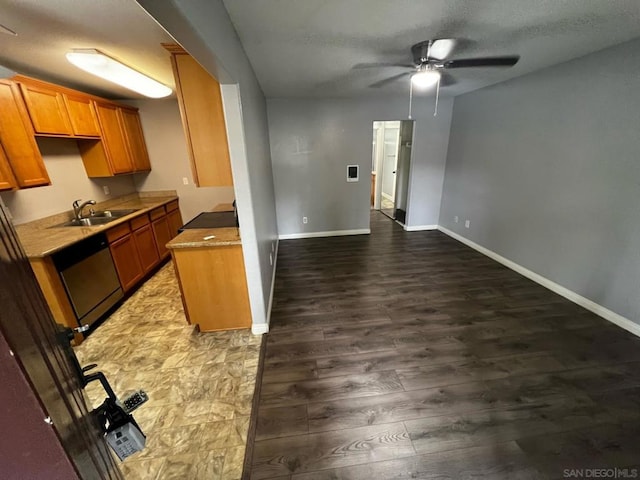 kitchen with ceiling fan, dishwasher, wood-type flooring, sink, and a textured ceiling