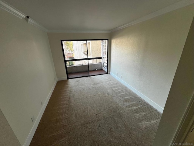 empty room with ornamental molding and carpet flooring