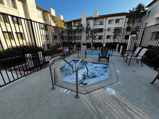 view of pool with a community hot tub