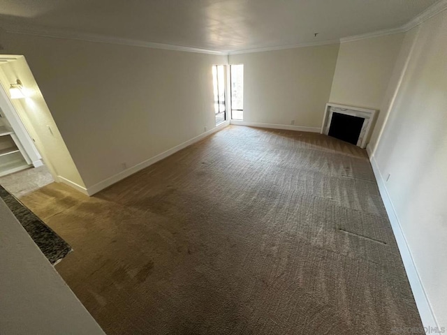 unfurnished living room with a fireplace, crown molding, and carpet flooring