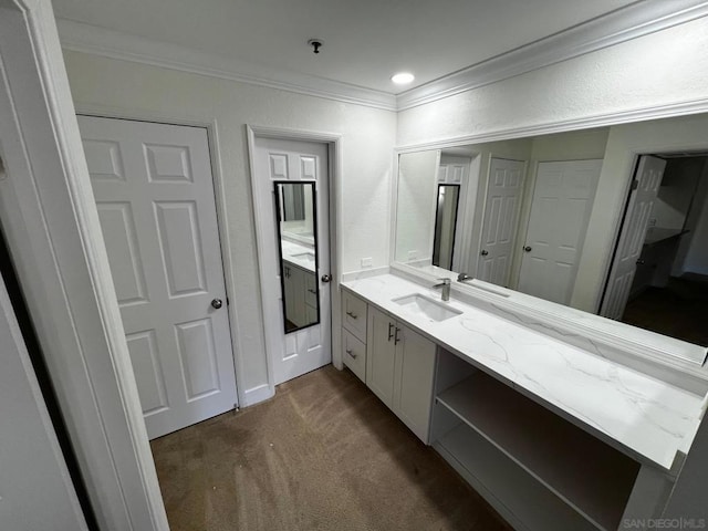 bathroom with ornamental molding and vanity