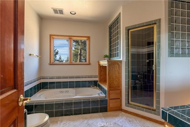 bathroom with tile patterned flooring, toilet, and plus walk in shower