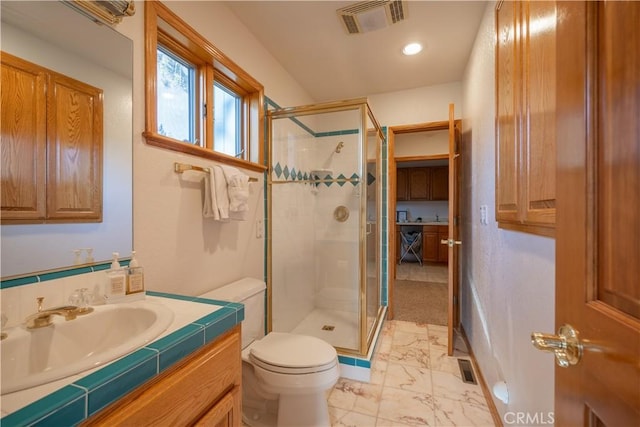 bathroom with toilet, walk in shower, and vanity