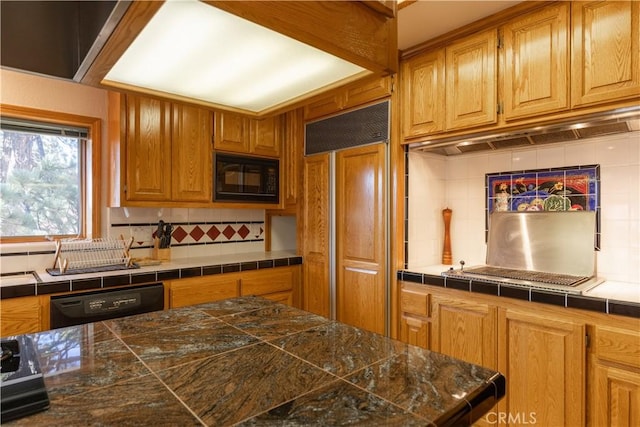 kitchen featuring black appliances and tasteful backsplash