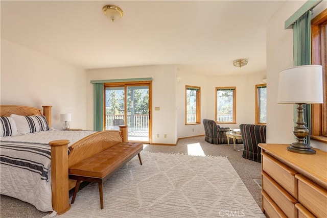 bedroom with light colored carpet and access to exterior