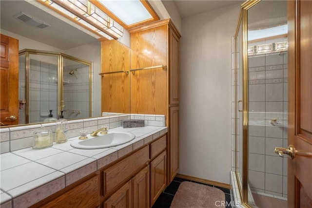 bathroom with tile patterned floors, an enclosed shower, and vanity