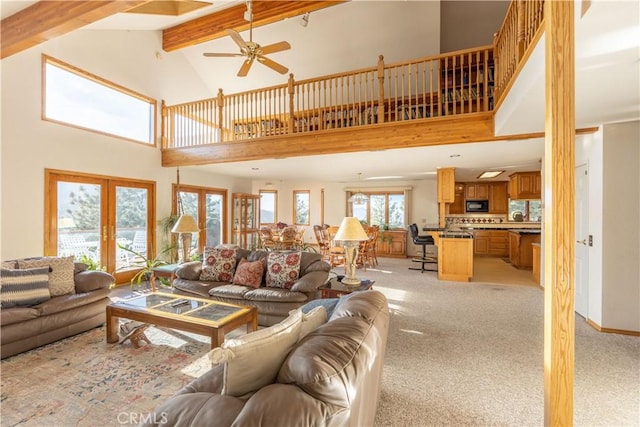 living room with high vaulted ceiling, light colored carpet, beam ceiling, and french doors