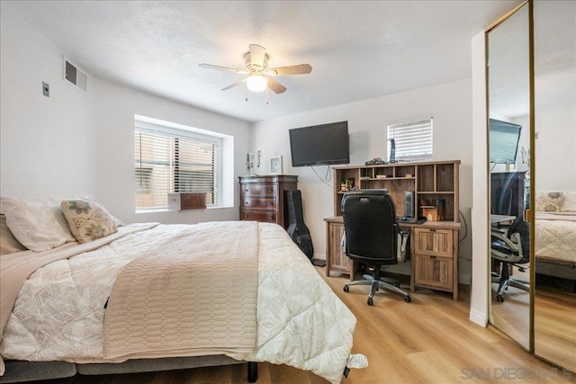 bedroom with ceiling fan and light hardwood / wood-style flooring