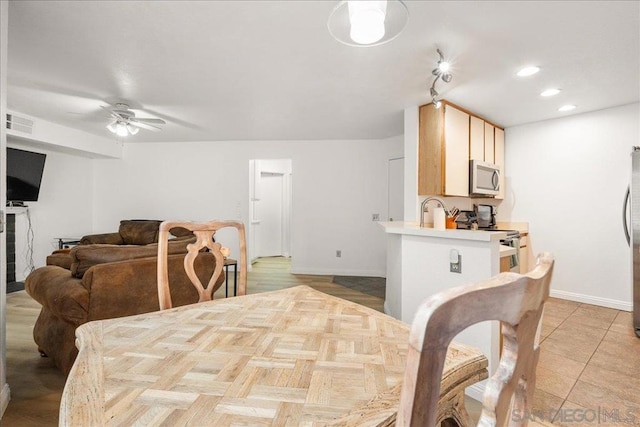 dining area featuring ceiling fan and sink