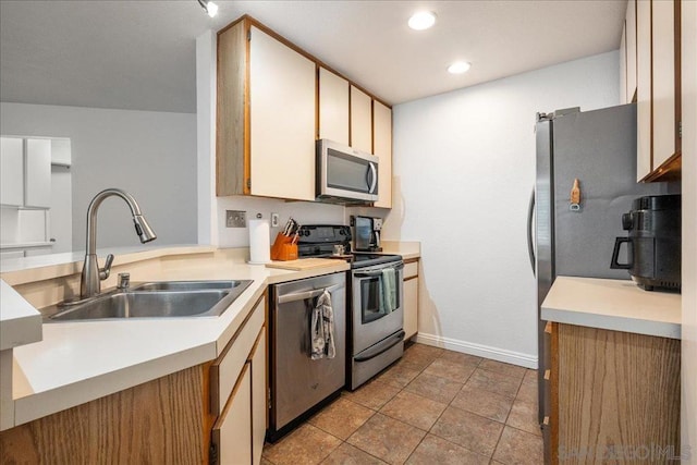 kitchen featuring light tile patterned floors, sink, and appliances with stainless steel finishes