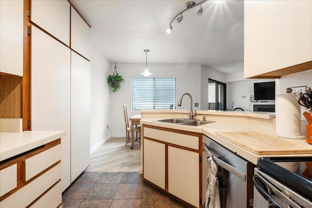 kitchen featuring white cabinetry, sink, dishwasher, and decorative light fixtures