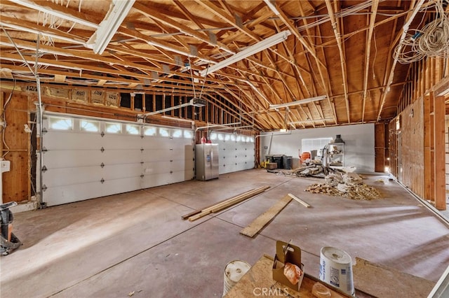 garage featuring stainless steel fridge and water heater