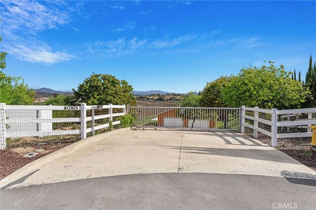 view of gate with a mountain view