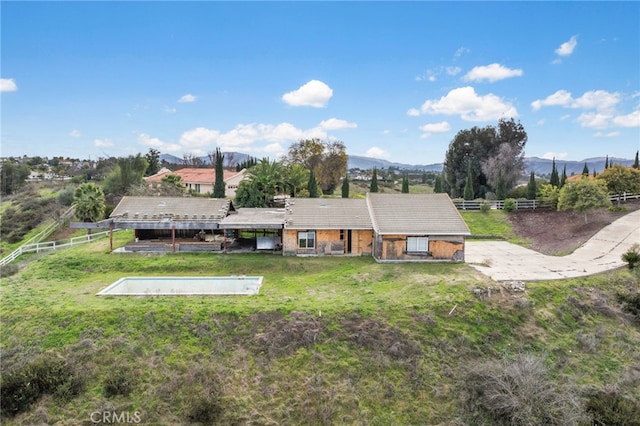 exterior space featuring a mountain view and a lawn