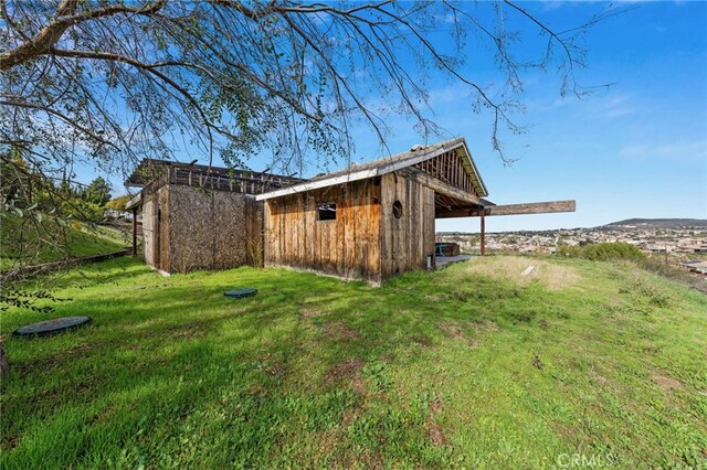 view of outbuilding with a lawn