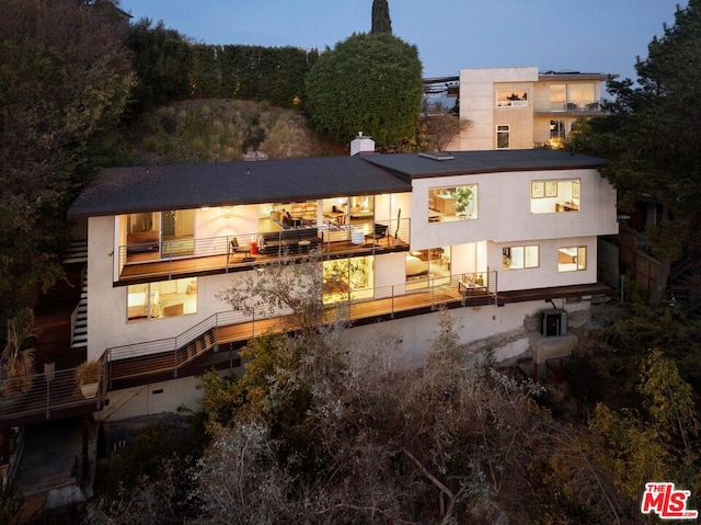 view of back house at dusk