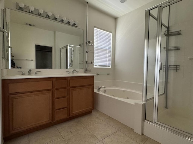 bathroom featuring plus walk in shower, vanity, and tile patterned flooring