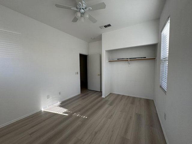 unfurnished bedroom with light wood-type flooring, a closet, and ceiling fan