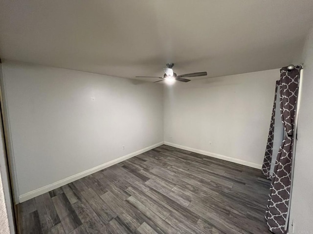 unfurnished room with ceiling fan and dark hardwood / wood-style flooring