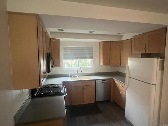 kitchen with dark wood-type flooring, electric range oven, white refrigerator, stainless steel dishwasher, and sink