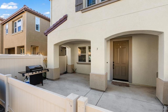 view of exterior entry featuring a patio