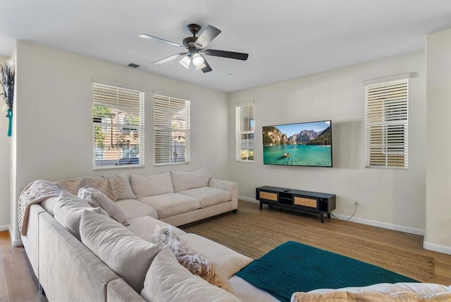 living room featuring light wood-type flooring and ceiling fan