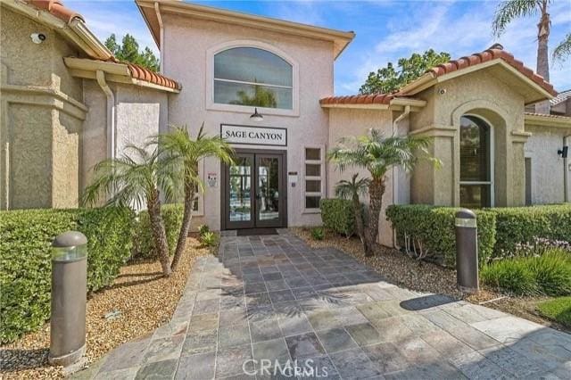 view of exterior entry featuring french doors