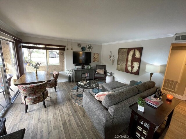 living room featuring ornamental molding and hardwood / wood-style flooring