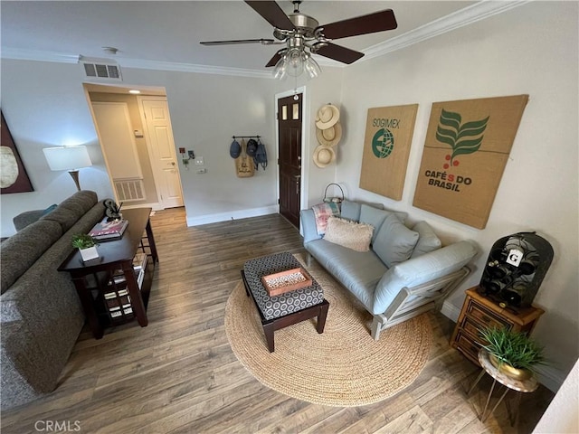 living room with ceiling fan, crown molding, and hardwood / wood-style flooring