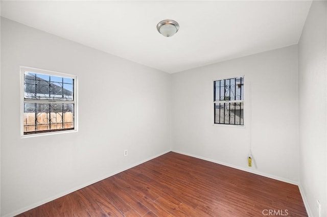 unfurnished room featuring hardwood / wood-style flooring