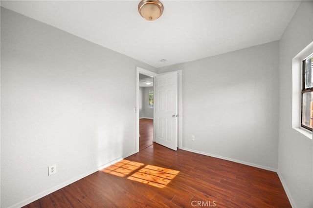 spare room featuring dark hardwood / wood-style flooring