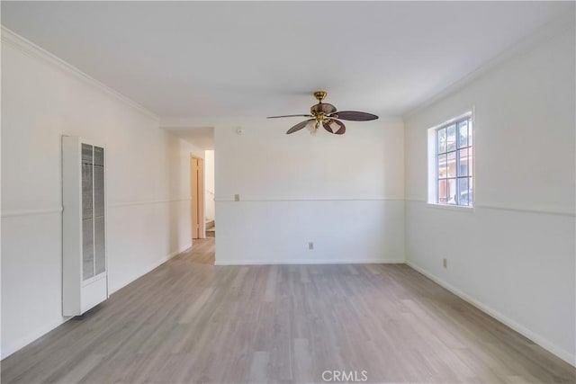 empty room featuring light wood-type flooring, ceiling fan, and ornamental molding