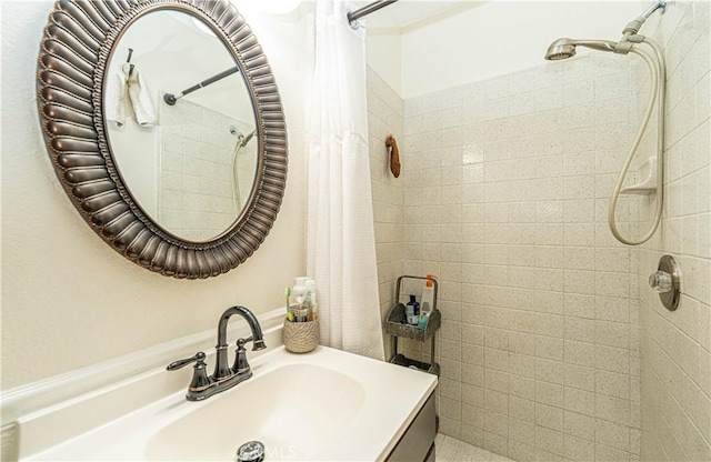 bathroom with walk in shower and vanity