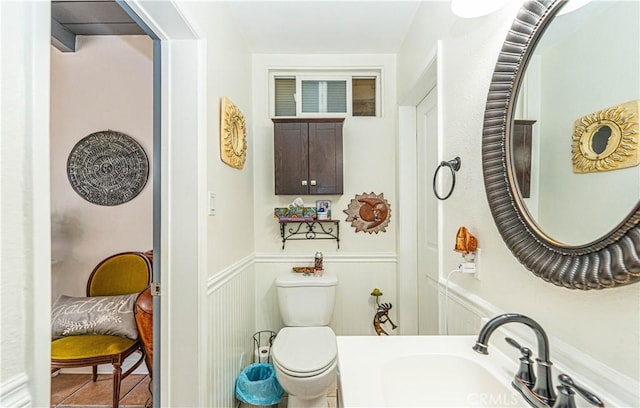 bathroom featuring sink, tile patterned floors, and toilet