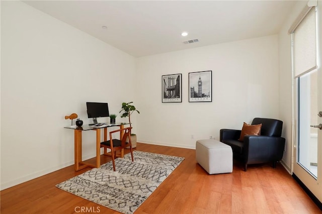 home office with wood-type flooring