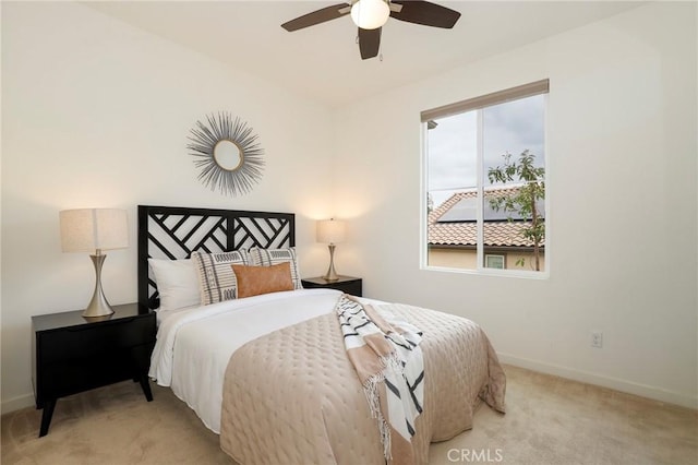 bedroom featuring ceiling fan and light carpet