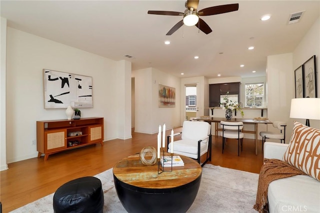 living room with ceiling fan and hardwood / wood-style floors