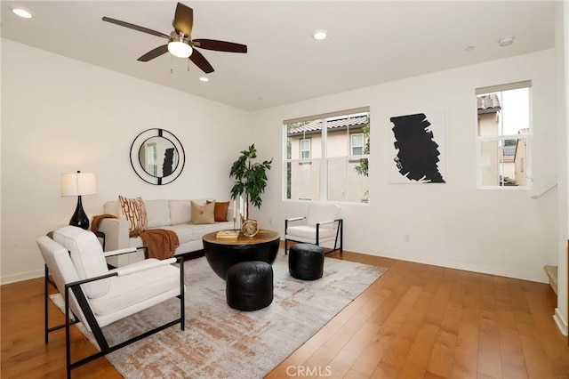 living room featuring hardwood / wood-style flooring and ceiling fan