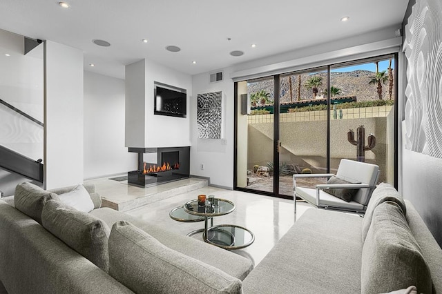 living room featuring a multi sided fireplace