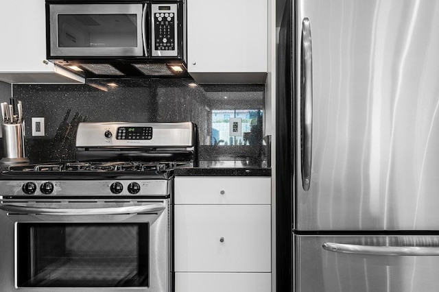 kitchen with decorative backsplash, appliances with stainless steel finishes, and white cabinetry