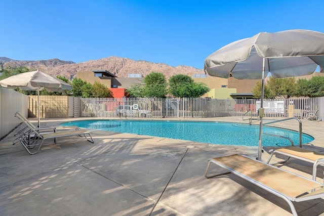 view of pool featuring a patio area and a mountain view