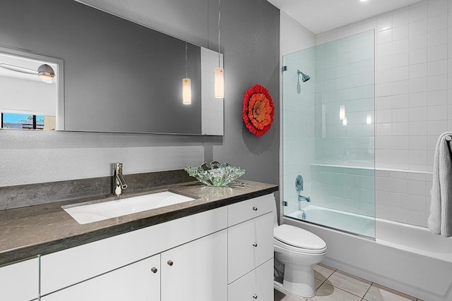 full bathroom with toilet, vanity, tiled shower / bath, and tile patterned flooring