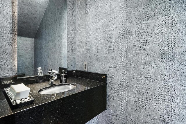 bathroom featuring vanity and vaulted ceiling