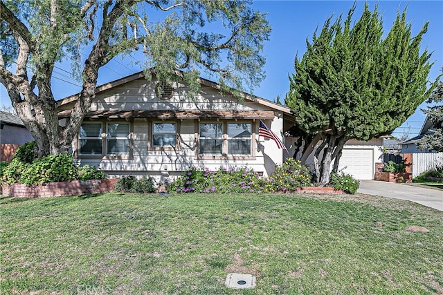 bungalow-style house with a garage and a front lawn