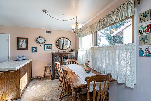 dining room featuring carpet and a notable chandelier