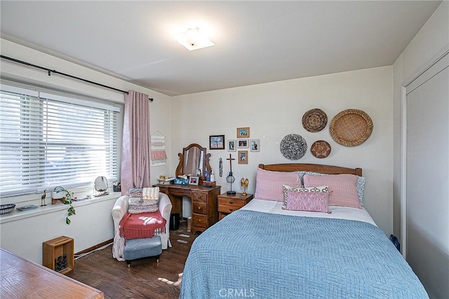 bedroom with dark hardwood / wood-style floors